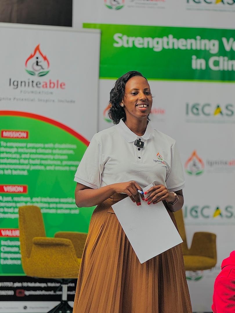A facilitator holding papers smiles during a workshop session.