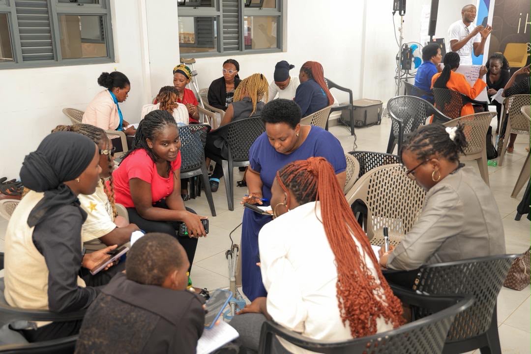 Participants seated in small circles during a breakout discussion at a community workshop.