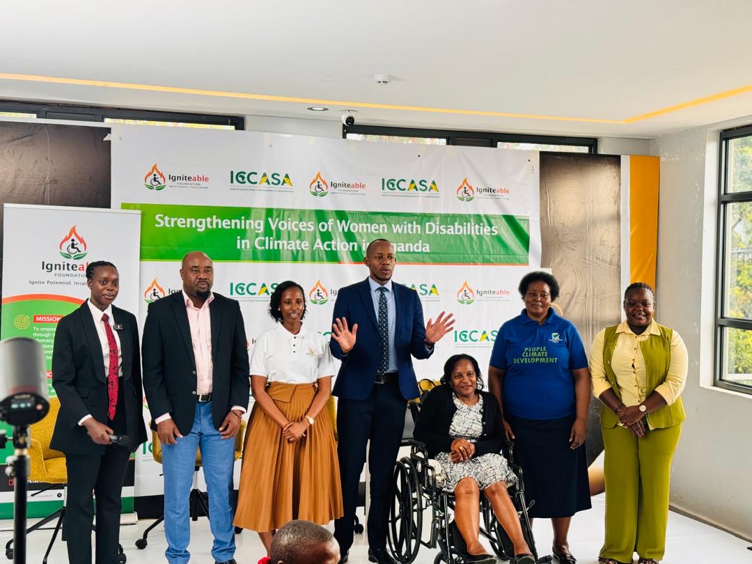 Speakers and partners on stage, including a woman using a wheelchair, at the Strengthening Voices workshop.
